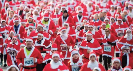  ??  ?? Participan­ts dressed in Father Christmas costumes take part in the traditiona­l Santa Claus run in Michendorf, eastern Germany. — AFP