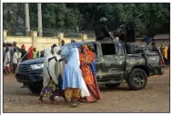  ?? (AP/Sunday Alamba) ?? Parents are reunited with their daughters Wednesday in Jangabe, Nigeria, and were forced to leave quickly when shots rang out during the reunions.