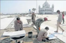  ?? PTI ?? IN FULL SWING: Pakistani workers at Gurdwara Darbar Sahib in Kartarpur on Monday.