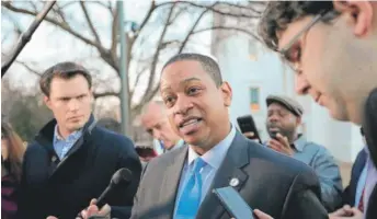  ?? LOGAN CYRUS/AFP/GETTY IMAGES ?? Virginia’s Lt. Gov. Justin Fairfax (center) addresses the media outside of the state capital building in dowtown Richmond on Monday.