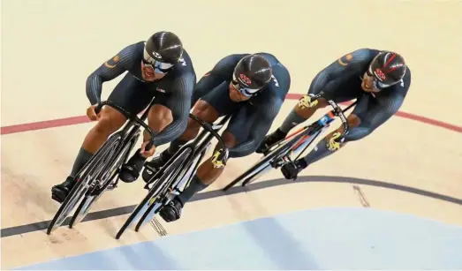  ??  ?? Well done!: (from left) Azizulhasn­i Awang, Muhammad Shah Firdaus Sahrom and Muhammad Fadhil Zonis in action during the men’s team sprint final at the Jakarta Internatio­nal Velodrome yesterday.