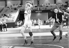  ?? WILLIE J ALLEN JR/ORLANDO SENTINEL ?? Osceola High School’s Gunner Holland and his coach Destin Macauley celebrate a state title in the 152-pound class of the FHSAA State Wrestling Tournament on Saturday in Kissimmee.