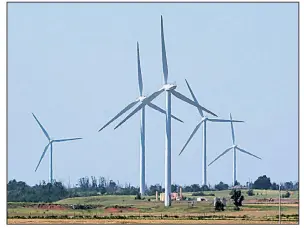  ?? AP file photo ?? Wind turbines are pictured near El Reno, Okla., last spring. Oklahoma has encouraged the growing wind-generation industry over the past 15 years with tax breaks and other incentives, but state budget deficits have prompted legislator­s to reverse...