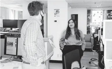  ?? TONY LUONG/THE NEW YORK TIMES ?? Sheeta Verma, 21, who usually works from home, pops into the office March 29 in Boston. After a year of working remotely, some employees are not keen to go back to the office, and so far, employers are being receptive to their concerns.