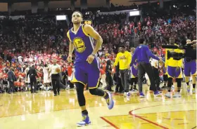  ?? David J. Phillip / Associated Press ?? Warriors guard Stephen Curry heads off the court at the end of the first half of Game 4 in Houston, just after slipping and spraining a right knee ligament.