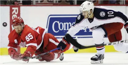  ??  ?? DETROIT: Columbus Blue Jackets center Alexander Wennberg (10), of Sweden, knocks the puck away from Detroit Red Wings defenseman Niklas Kronwall (55), also of Sweden, during the first period of an NHL hockey game Friday, in Detroit. — AP
