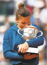  ?? Cameron Spencer / Getty Images ?? Simona Halep lets go of her emotions after winning the French Open for her first Grand Slam title.