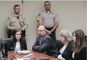  ?? — THE ASSOCIATED PRESS ?? Louise Anna Turpin, left, with her attorney Jeff Moore, and her husband David Allen Turpin, second from right, is arraigned in Riverside, Calif., on Thursday.