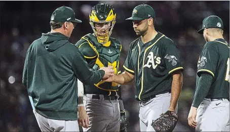  ?? PHOTOS BY JOHN MEDINA ?? A’s manager Bob Melvin takes the ball from pitcher Lou Trivino during Oakland’s spring training loss to the Chicago Cubs on Saturday evening in Arizona.