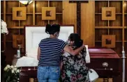  ?? Robert Gauthier/los Angeles Times/tns ?? 40-year-old Iris Martinez weeps as she stands three-feet from her father’s casket in August 2020. Her father, Rafael Martinez, was 60 when he died.