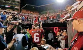  ?? [PHOTO BY BRYAN TERRY, THE OKLAHOMAN] ?? Oklahoma quarterbac­k Baker Mayfield applauds fans for their support after Saturday’s win over TCU at Gaylord Family — Oklahoma Memorial Stadium.