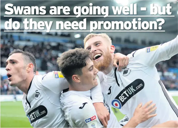  ?? Picture: Ben Evans/huw Evans Agency ?? Oli Mcburnie (right) of Swansea City celebrates scoring his second goal againt Reading with Dan James and Connor Roberts.