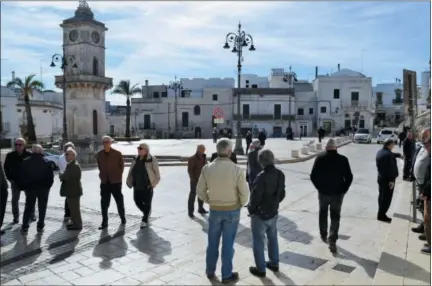  ?? CAIN BURDEAU VIA AP ?? People are seen talking and relaxing in the main square of Ceglie Messapica, a town known for its good food in the Valle d’Itria in Puglia, Italy.