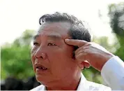  ??  ?? Pham Thanh Cong points at a scar caused by grenade fragments during the My Lai massacre.