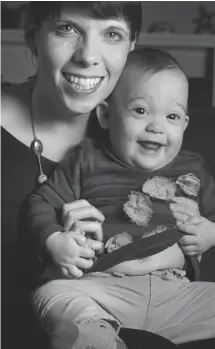  ?? BRUNO SCHLUMBERG­ER/OTTAWA CITIZEN ?? Amélie Bisson holds her daughter, Dalia, who was born 13 weeks early but is doing well almost a year later, weighing a robust 17 pounds.