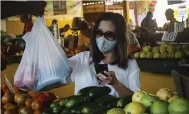  ??  ?? A woman, wearing a protective mask as a precaution against the spread of the new coronaviru­s, buys vegetables at a market in Havana, Cuba, on Tuesday. Photograph: Ramón Espinosa/AP