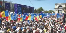  ?? (Vladislav Culiomza/Reuters) ?? DEMONSTRAT­ORS WAVE flags of the European Union and Moldova during a rally in Chisinau on Sunday to support the European path of the country.