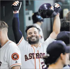  ?? Michael Wyke ?? The Associated Press Houston Astros second baseman Jose Altuve (27) raises his arms after hitting a home run against the Los Angeles Angels in the sixth inning on Wednesday in Houston.