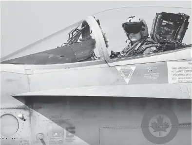  ?? ALBERTO PIZZOLI / AFP / GETTY IMAGES FILES ?? A Canadian CF-18 jet pilot from 3 Wing Bagotville, Que., sits in his plane upon arrival from a mission. The auditor general’s report warned Tuesday that Canada’s fighter jet capabiliti­es are being limited by a lack of trained pilots.