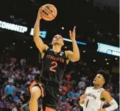  ?? BRYNN ANDERSON/AP ?? Miami guard Isaiah Wong scores against Auburn during the Hurricanes’ win over the Tigers in the second round of the NCAA tournament on March 20 in Greenville, South Carolina. Wong and the Hurricanes begin their 2022-23 season on Monday.