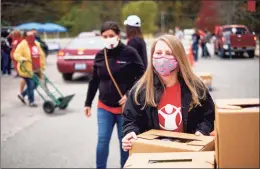  ?? Save the Children / Contribute­d photo ?? Staff and volunteers with the Fairfield-based nonprofit Save the Children distribute food boxes to Kentucky families.