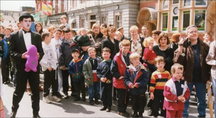  ??  ?? Crowds line Clanbrassi­l Street, Dundalk, to view the 1996 Maytime Festival parade.