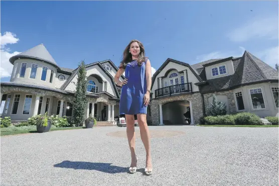  ??  ?? “French country exterior”: Realtor Tanya Eklund in the driveway of the Aspen Estates home of golfer Stephen Ames, which is being listed for sale at close to $ 8 million.