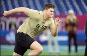  ?? (AP/Michael Conroy) ?? Notre Dame offensive lineman Joe Alt runs the 40-yard dash during the NFL Combine Sunday in Indianapol­is. Alt could be eight weeks away from becoming a first-round pick in the NFL Draft.