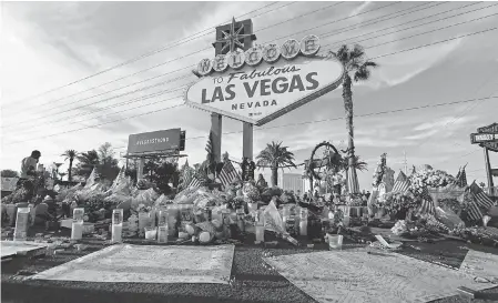  ??  ?? A makeshift memorial was set up in Las Vegas for the 58 Route 91 Harvest Festival shooting fatalities. JOHN LOCHER/AP