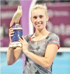  ?? - AFP photo ?? Belgian Elise Mertens poses with the trophy after her victory over Romanian Simona Halep in their WTA Qatar Open final tennis match in Doha on February 16, 2019.