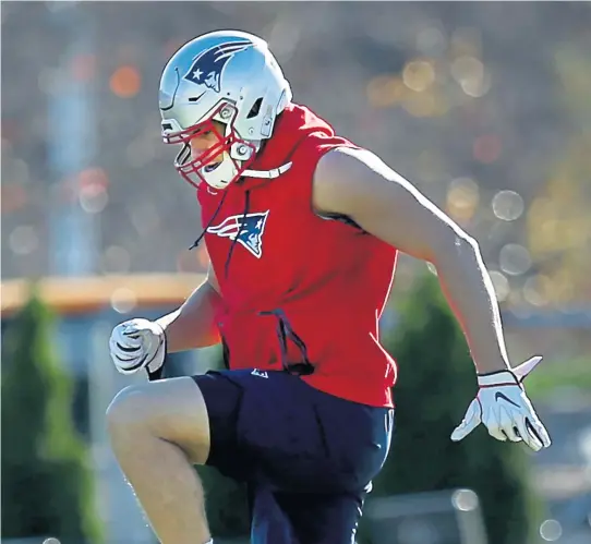  ?? NANCY LANE / BOSTON HERALD ?? SPRING IN HIS STEP: Rob Gronkowski loosens up during practice this week at Gillette Stadium, but the Patriots tight end remains questionab­le for tomorrow’s game against Tennessee.