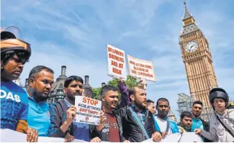  ?? NIKLAS HALLE’N, AFP/ GETTY IMAGES ?? Motorcycle delivery drivers and motorcycli­sts take part in a demonstrat­ion in Parliament Square in central London on July 18 after a spate of acid attacks.