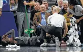  ?? Hannah Foslien / Associated Press ?? Nets guard Caris LeVert is tended to after suffering what appeared to be a severe leg injury that left many players in tears.