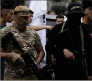  ?? (AP/Majdi Mohammed) ?? Gunmen wearing Islamic Jihad headbands attend the funeral of Matin Dababa on Friday in the Jenin refugee camp.