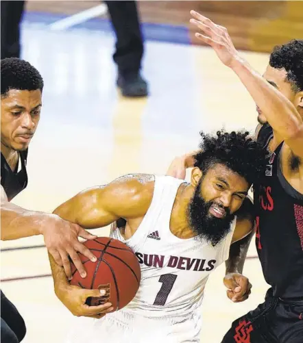  ?? ROSS D. FRANKLIN AP ?? Arizona State guard Remy Martin was held to nine points by defense like this from Matt Mitchell (left) and guard Trey Pulliam.