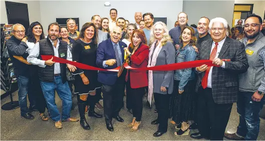  ?? ?? Santa Fe Chamber of Commerce staff and board members celebrate the ribbon cutting at the chamber’s new offices.