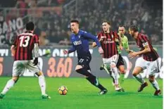  ?? AFP ?? Lazio’s Serbian midfielder Sergej Milinkovic-Savic (centre) vies with AC Milan players during their Coppa Italia semi-final first leg at San Siro stadium on Tuesday.