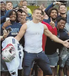  ?? STaff phoTo by NaNCy LaNE ?? CLASS CLOWN: Rob Gronkowski poses for a photo with the University of Rhode Island football team after yesterday’s Patriots practice at Gillette Stadium.