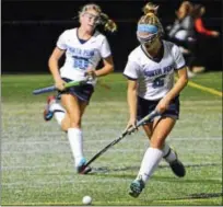  ?? DEBBY HIGH/FOR DIGITAL FIRST MEDIA ?? North Penn’s Bri O’Donnell keeps the ball at bay as her teammate Emily Crawford moves down the field Monday against Souderton.