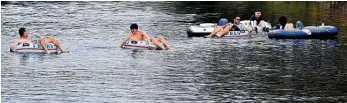  ??  ?? People cruise the Comal River on Sunday in New Braunfels as spring break brings the start of tubing season.