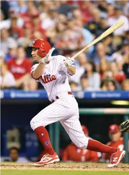  ??  ?? Phillies' Ty Kelly watches his RBI double off Boston Red Sox's Chris Sale during the eighth inning of a baseball game in Philadelph­ia on Thursday. (AP)