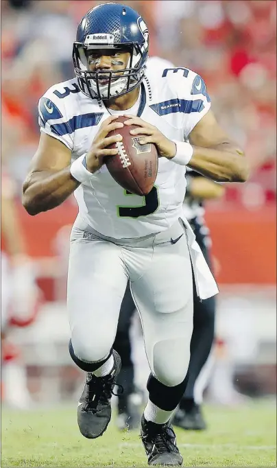  ?? — GETTY IMAGES ?? Russell Wilson of the Seattle Seahawks scrambles during the NFL pre-season game against the Kansas City Chiefs at Arrowhead Stadium.