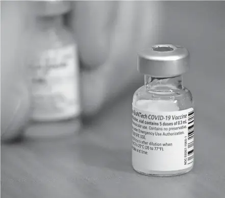  ?? SENTINEL VIA USA TODAY NETWORK] [MIKE DE SISTI / MILWAUKEE JOURNAL ?? A COVID-19 vaccine is prepared on Dec. 16 at Ascension SE Wisconsin Hospital in Franklin, Wisconsin.