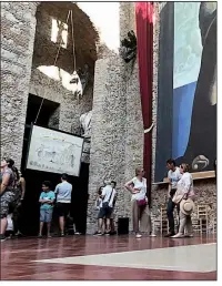  ?? AP/HERNAN MUNOZ ?? Visitors stand near the tomb of Salvador Dali inside the Dali Museum Theatre in Figueres, Spain. The site makes up one part of Spain’s “Dali Triangle.”