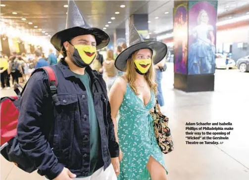  ?? AP ?? Adam Schaefer and Isabella Phillips of Philadelph­ia make their way to the opening of “Wicked” at the Gershwin Theatre on Tuesday.