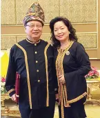  ??  ?? Dompok and his wife Puan Sri Diana clad in traditiona­l costume after the ceremony at Istana Negara.