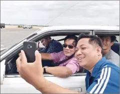  ?? FACEBOOK ?? Prime Minister Hun Sen takes a photograph with a supporter during an outing with family members yesterday.