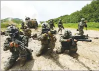  ?? AP PHOTO ?? South Korean and U.S. marines aim their machine guns during a joint military exercise between the two countries in Pohang, South Korea.