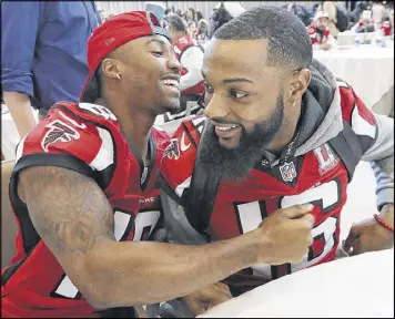  ?? CURTIS COMPTON / CCOMPTON@AJC.COM ?? Falcons wide receivers Taylor Gabriel (left) and Justin Hardy share a laugh during media interviews at the Super Bowl in Houston. Gabriel tied for the Falcons’ lead in touchdown catches this season with six.