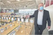  ?? FRANK GUNN THE CANADIAN PRESS ?? Premier Doug Ford tours a COVID-19 mass vaccinatio­n clinic in Toronto on Monday. The pandemic has hammered Ontario’s universiti­es, but not before Ford did, Martin Regg Cohn writes.